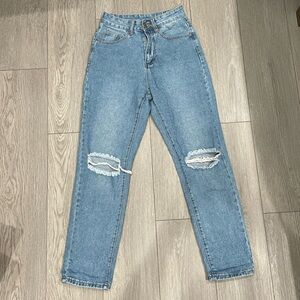 Medium Wash High Waisted Mom Jeans with distressing at the knees.